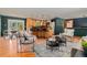 Inviting living room with wood floors open to a modern kitchen with stainless appliances at 15 Pawnee Dr, Boulder, CO 80303