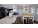 Modern kitchen with stainless steel appliances and white countertops, and a dining area with a dining table at 5360 Monaco St, Commerce City, CO 80022