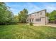 Expansive backyard featuring a lush lawn, mature trees, and gravel landscaping for a serene outdoor experience at 20738 E Grand Pl, Aurora, CO 80015