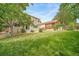 A spacious backyard featuring a lush lawn and mature trees, perfect for outdoor activities and relaxation at 20738 E Grand Pl, Aurora, CO 80015