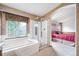 A bright bathroom showcasing a garden tub with a glass shower enclosure at 20738 E Grand Pl, Aurora, CO 80015
