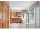 Bathroom featuring a double vanity, large mirror, soaking tub, and glass-enclosed shower at 20738 E Grand Pl, Aurora, CO 80015