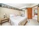 Cozy bedroom with a beautiful, mirrored closet, carpet flooring, and a quaint, wooden side table at 20738 E Grand Pl, Aurora, CO 80015