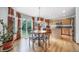 Eat-in kitchen with wood floors, a round table, and access to a sunny backyard patio at 20738 E Grand Pl, Aurora, CO 80015
