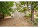 A detail of the house exterior with rock ground cover, downspout, and trees at 20738 E Grand Pl, Aurora, CO 80015