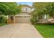 Charming two-story home with a spacious driveway, well-maintained lawn, and attached two-car garage at 20738 E Grand Pl, Aurora, CO 80015