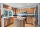 Well-lit kitchen featuring stainless steel appliances and center island at 20738 E Grand Pl, Aurora, CO 80015