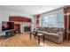Comfortable living room features a fireplace, hardwood floors, and large windows at 20738 E Grand Pl, Aurora, CO 80015