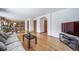 Open living room area with hardwood floors, views of kitchen, and multiple doorways at 20738 E Grand Pl, Aurora, CO 80015