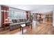 Spacious living room with hardwood floors, large windows, and an adjacent kitchen area at 20738 E Grand Pl, Aurora, CO 80015