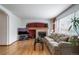 Cozy living room features a brick fireplace, hardwood floors, and large windows at 20738 E Grand Pl, Aurora, CO 80015