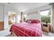 Spacious main bedroom with a large bed, windows, and ensuite bathroom access at 20738 E Grand Pl, Aurora, CO 80015
