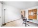 A bright office space with carpet flooring, double door closet, and a simple modern desk setup at 20738 E Grand Pl, Aurora, CO 80015