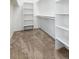 Walk-in closet featuring shelving and carpet at 8896 Goosander Way, Littleton, CO 80126