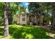 Spacious backyard features lush green grass, mature trees, and a deck for outdoor enjoyment at 5530 Racquet Ln, Boulder, CO 80303