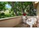 Inviting balcony features a chair, table, and privacy, perfect for relaxing outdoors at 5530 Racquet Ln, Boulder, CO 80303