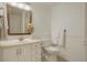 Neutral bathroom features a vanity with a framed mirror, white toilet, and trim at 5530 Racquet Ln, Boulder, CO 80303