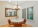 Cozy dining area features a modern chandelier, a round table, and a large window with natural light at 5530 Racquet Ln, Boulder, CO 80303