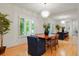 Elegant dining room featuring hardwood floors, a large mirror, a modern chandelier, and plantation shutters for natural light at 5530 Racquet Ln, Boulder, CO 80303
