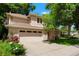 Lovely two-story home showcasing a two-car garage, mature trees, and a well-manicured lawn, creating a welcoming curb appeal at 5530 Racquet Ln, Boulder, CO 80303