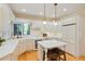 Bright kitchen featuring white cabinets, modern appliances, an island with seating, and hardwood floors, creating a culinary haven at 5530 Racquet Ln, Boulder, CO 80303