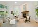Bright living room with vaulted ceilings, a cozy fireplace, plantation shutters, and comfortable seating, great for relaxation at 5530 Racquet Ln, Boulder, CO 80303