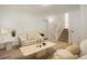 Spacious living room featuring neutral colored walls, plush furniture and a staircase at 5530 Racquet Ln, Boulder, CO 80303
