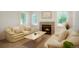Cozy living room with fireplace, neutral-colored furniture, and bright windows for natural light at 5530 Racquet Ln, Boulder, CO 80303