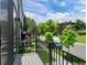Balcony view overlooking a quiet street with lush greenery and a blue sky at 7066 W 13Th Ave, Lakewood, CO 80214