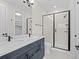 Modern bathroom with double vanity, tiled shower, and matte black fixtures at 7066 W 13Th Ave, Lakewood, CO 80214