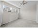 Empty Bedroom featuring ceiling fan, large windows and carpet at 7066 W 13Th Ave, Lakewood, CO 80214