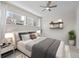 Cozy bedroom featuring a ceiling fan, large windows, and decorative shelving at 7066 W 13Th Ave, Lakewood, CO 80214