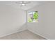 Minimalist bedroom with a ceiling fan, window with green tree view, and light hardwood flooring at 7066 W 13Th Ave, Lakewood, CO 80214