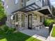 Stylish townhome entrance with stone accents, modern lighting, and covered entryway for added curb appeal at 7066 W 13Th Ave, Lakewood, CO 80214