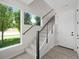 Bright entryway featuring a staircase with cable railings, leading to the upper levels of the home at 7066 W 13Th Ave, Lakewood, CO 80214