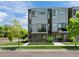 Contemporary home with a well-manicured lawn, stone accents, and large windows for ample natural light at 7066 W 13Th Ave, Lakewood, CO 80214