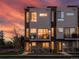 Modern townhome features sleek architectural details and private balcony with beautiful sunset view at 7066 W 13Th Ave, Lakewood, CO 80214