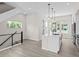 Bright, open kitchen with a white island, modern pendant lights, and stainless steel appliances at 7066 W 13Th Ave, Lakewood, CO 80214