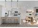 Open kitchen with a large island, modern pendant lighting, and seating at 7066 W 13Th Ave, Lakewood, CO 80214