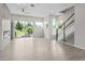 Spacious living room with large windows, a modern ceiling fan, and staircase access at 7066 W 13Th Ave, Lakewood, CO 80214