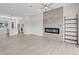 Open-concept living space with fireplace feature wall and modern shelving in neutral tones at 7066 W 13Th Ave, Lakewood, CO 80214