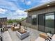 Entertainer's rooftop deck with outdoor seating, a fire pit, and scenic neighborhood views at 7066 W 13Th Ave, Lakewood, CO 80214