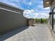 Serene rooftop deck with gray tile flooring, string lights, and lush green neighborhood views at 7066 W 13Th Ave, Lakewood, CO 80214