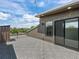 Modern rooftop deck with stylish gray tile and outdoor access through sliding glass doors at 7066 W 13Th Ave, Lakewood, CO 80214