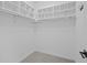 Bright walk-in closet featuring carpet flooring, white shelving, and ample storage space at 7066 W 13Th Ave, Lakewood, CO 80214