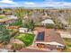 Aerial view of a home with solar panels, a backyard oasis, and mature trees in a neighborhood setting at 7100 W Ellsworth Pl, Lakewood, CO 80226