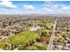 Aerial shot of neighborhood, park and lake with Denver skyline visible in the distance at 7100 W Ellsworth Pl, Lakewood, CO 80226