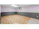Finished basement with paneling, carpet, and vinyl flooring, and small window at 7100 W Ellsworth Pl, Lakewood, CO 80226