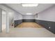 Large finished basement with carpet and vinyl flooring, and paneling at 7100 W Ellsworth Pl, Lakewood, CO 80226