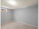 Basement bedroom with carpet floors, a small window, and a neutral color palette at 7100 W Ellsworth Pl, Lakewood, CO 80226